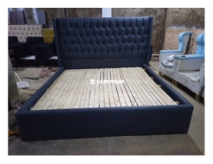 A WOODEN TUFTED BED SET