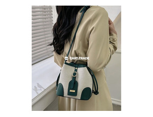 white and dark green bucket bag